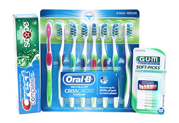West Palm Beach, USA - May 2, 2014: Dental hygiene products: Crest Complete Toothpaste with Scope, Oral B Crisscross toothbrushes, and Sunstar GUM Soft-Picks. Toiletries for dental healthcare.